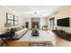 Staged living room features a stone fireplace, lots of natural light, and hardwood flooring at 8464 Pleasant Hill Rd, Lithonia, GA 30058