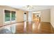 Spacious living room features hardwood floors, natural light, and access to a private balcony at 8464 Pleasant Hill Rd, Lithonia, GA 30058