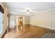 Sun-drenched living room, hardwood flooring, with access to the kitchen at 8464 Pleasant Hill Rd, Lithonia, GA 30058