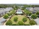 Expansive aerial view of a community featuring a manicured lawn, clubhouse, and resort style community pool at 124 Calder Dr, Alpharetta, GA 30009