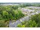 Scenic aerial view of a townhome community with lush greenery, ponds, and a mix of residential buildings at 124 Calder Dr, Alpharetta, GA 30009
