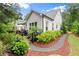 Charming backyard featuring a stone walkway, manicured landscaping, and a cozy patio with outdoor seating, perfect for relaxation at 124 Calder Dr, Alpharetta, GA 30009