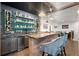 Entertaining home bar features custom shelving, bar seating, and modern design at 124 Calder Dr, Alpharetta, GA 30009