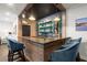 Stylish home bar featuring custom lighting, wooden accents, and sleek countertops at 124 Calder Dr, Alpharetta, GA 30009