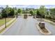 Elegant gated community entrance with brick pillars, manicured landscaping, and a secure entry point at 124 Calder Dr, Alpharetta, GA 30009