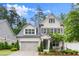 Beautiful two-story home featuring gray painted brick, gray shutters, and a well-manicured lawn at 124 Calder Dr, Alpharetta, GA 30009