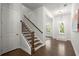 Hallway with hardwood floors, staircase, and view into a naturally lit room at 124 Calder Dr, Alpharetta, GA 30009