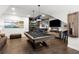 Well-appointed game room featuring a pool table, a wet bar, and hardwood floors at 124 Calder Dr, Alpharetta, GA 30009