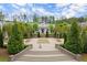 A community green space featuring landscaping, a brick staircase, and manicured lawn at 124 Calder Dr, Alpharetta, GA 30009