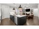 Open concept kitchen with large island flowing into the living room and fireplace at 124 Calder Dr, Alpharetta, GA 30009