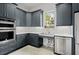 Modern kitchen featuring gray cabinets, stainless steel appliances, and a bright window with a view at 124 Calder Dr, Alpharetta, GA 30009