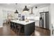 Spacious white and dark gray kitchen with a large island, stainless steel appliances, and hardwood floors at 124 Calder Dr, Alpharetta, GA 30009