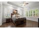 Spacious main bedroom featuring hardwood floors, tray ceiling, and lots of natural light at 124 Calder Dr, Alpharetta, GA 30009