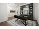 Stylish home office featuring dark built-in cabinets, hardwood floors, and a modern desk at 124 Calder Dr, Alpharetta, GA 30009