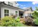Inviting patio with stone flooring, comfortable seating, TV, and a beautifully landscaped backyard with lush greenery at 124 Calder Dr, Alpharetta, GA 30009