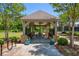 Community picnic pavilion featuring a picnic table and ceiling fans, surrounded by landscaping and grass at 124 Calder Dr, Alpharetta, GA 30009