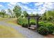 A gravel walking path with a wooden swing, surrounded by grass and landscaping at 124 Calder Dr, Alpharetta, GA 30009