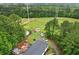 A lush acreage with mature trees; aerial view shows home plus a storage shed at 1368 Tommy Lee Cook Rd, Palmetto, GA 30268