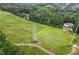 Aerial view of a lush property with electric lines and mature trees surrounding the home at 1368 Tommy Lee Cook Rd, Palmetto, GA 30268