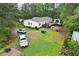 A lush back yard with a deck, pergola, and two parking spaces for cars at 1368 Tommy Lee Cook Rd, Palmetto, GA 30268