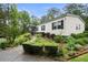 View of charming one story home with a covered front porch and landscaped yard at 1368 Tommy Lee Cook Rd, Palmetto, GA 30268