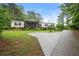 Well-maintained single-story home with a screened porch and driveway at 1368 Tommy Lee Cook Rd, Palmetto, GA 30268