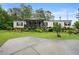 Charming single-story home with a screened porch and beautiful landscaping at 1368 Tommy Lee Cook Rd, Palmetto, GA 30268