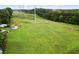 Expansive, green front yard featuring mature trees and electric lines at 1368 Tommy Lee Cook Rd, Palmetto, GA 30268