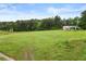 Expansive, green front yard featuring an idyllic country view and mature trees at 1368 Tommy Lee Cook Rd, Palmetto, GA 30268