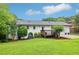 A backyard with a lawn, patio, small deck, and freshly painted white brick exterior make this house ready for entertaining at 3036 Horse Shoe Se Dr, Atlanta, GA 30316
