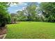 Well-maintained backyard featuring a spacious lawn and lush greenery, perfect for outdoor activities at 3036 Horse Shoe Se Dr, Atlanta, GA 30316