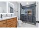 Modern bathroom with dual vanity, walk-in shower with tile surround, and stone flooring at 3036 Horse Shoe Se Dr, Atlanta, GA 30316