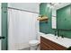 Stylish bathroom with green walls, modern vanity, and a black faucet at 3036 Horse Shoe Se Dr, Atlanta, GA 30316