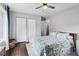 Comfortable bedroom features a ceiling fan, closet, and stylish leaf-pattern bedding at 3036 Horse Shoe Se Dr, Atlanta, GA 30316