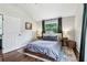 Well-lit bedroom boasts hardwood floors, two side tables, and a large window at 3036 Horse Shoe Se Dr, Atlanta, GA 30316