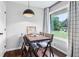 Well-lit dining space with a wooden table and large window boasts an inviting atmosphere at 3036 Horse Shoe Se Dr, Atlanta, GA 30316