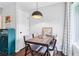 Bright dining room features a wooden table and stylish light fixture near a large window at 3036 Horse Shoe Se Dr, Atlanta, GA 30316