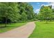 A paved walking path lined with trees and green grass offers a serene escape for residents in this neighborhood at 3036 Horse Shoe Se Dr, Atlanta, GA 30316