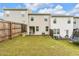 Fenced backyard with a patio, green lawn, and space for outdoor enjoyment at 5668 Union Pointe Dr, Union City, GA 30291