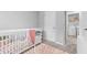 Bright Bedroom featuring a crib and a view into the laundry room at 5668 Union Pointe Dr, Union City, GA 30291