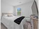 Cozy bedroom featuring a plush bed, window view, and wooden dresser at 5668 Union Pointe Dr, Union City, GA 30291
