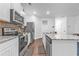 Well-equipped kitchen with stainless steel appliances, granite countertops, and a functional island with seating at 5668 Union Pointe Dr, Union City, GA 30291