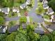 A high-angle shot shows houses bordering a street, partially concealed by lush green foliage, with mature trees at 10795 Glenbarr Dr, Johns Creek, GA 30097