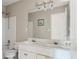 Bathroom features a double sink vanity with a large mirror, tiled shower and neutral colors at 10795 Glenbarr Dr, Johns Creek, GA 30097