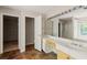 Bathroom with double sinks, large mirror and vanity next to the walk-in shower at 10795 Glenbarr Dr, Johns Creek, GA 30097