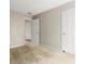 Neutral bedroom features tan carpet and access to another room via a white door at 10795 Glenbarr Dr, Johns Creek, GA 30097