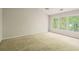 Large bedroom with carpeted floors, ceiling fan, and many large windows at 10795 Glenbarr Dr, Johns Creek, GA 30097