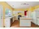 Kitchen with an island, white cabinetry, view to the living room and stainless steel appliances at 10795 Glenbarr Dr, Johns Creek, GA 30097