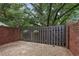 Brick-lined patio area featuring a privacy fence and hanging flower baskets at 1245 S Ponce De Leon Ne Ave # 13, Atlanta, GA 30306