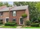Classic brick townhome with lush green landscaping and a welcoming entrance at 1245 S Ponce De Leon Ne Ave # 13, Atlanta, GA 30306
